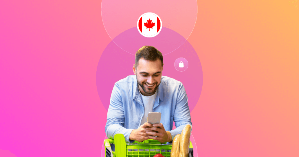 Smiling man in a light blue shirt using his smartphone while leaning on a shopping cart filled with groceries. The background features a gradient of pink and orange with circular graphics, including a Canadian flag icon and shopping-related symbols, representing the shopper experience in Canada.