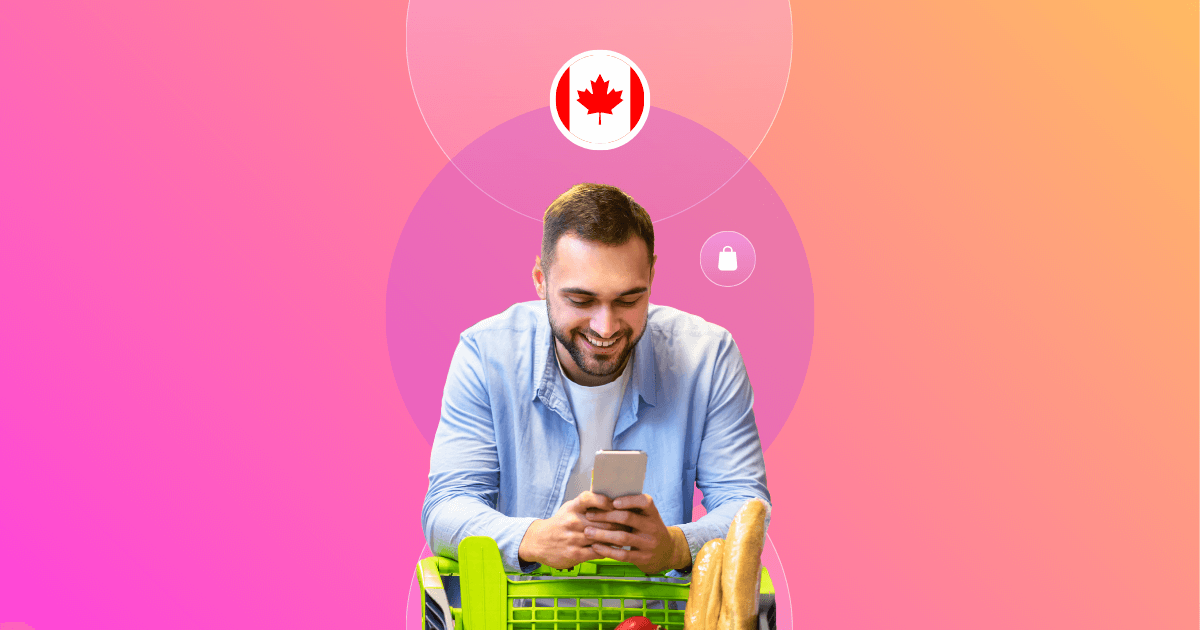 Smiling man in a light blue shirt using his smartphone while leaning on a shopping cart filled with groceries. The background features a gradient of pink and orange with circular graphics, including a Canadian flag icon and shopping-related symbols, representing the shopper experience in Canada.